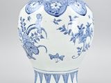 a blue and white vase sitting on a table