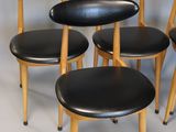 six black leather stools with wooden legs and a black leather seat