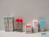 many different types of skin care products displayed on a table