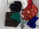 a bag of clothes and a hat sitting on a bed