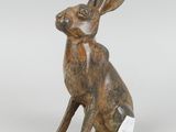 a bronze statue of a rabbit sitting on its hind legs