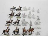 many figurines of people riding horses on a white surface