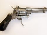 gros plan d'un revolver sur une surface blanche