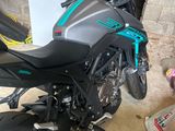 a motorcycle that is parked in a garage next to a box