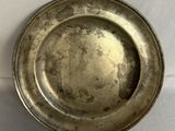 a silver plate that is on a white table