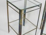 pair of chrome and glass side tables with a glass top