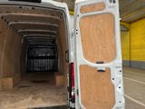 a white van with a wooden door open in a building