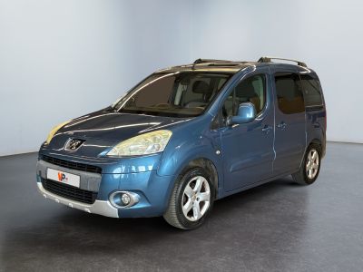 the small blue van is parked in a large room