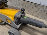a yellow and black machine that is sitting on the ground
