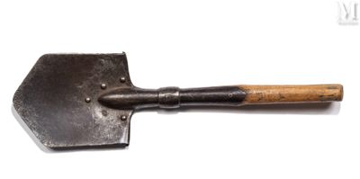 a close up of a metal shovel with a wooden handle on a white surface