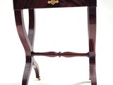 a small wooden table with a drawer on top of it