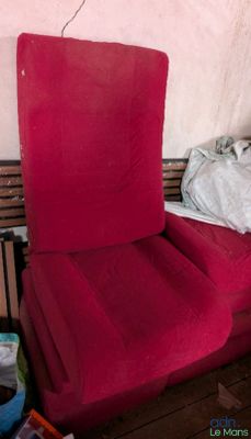 a red chair that is sitting in the corner of a room