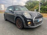 a picture of a black mini cooper parked on the side of the road