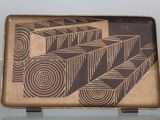 a tray with a design on it sitting on a table