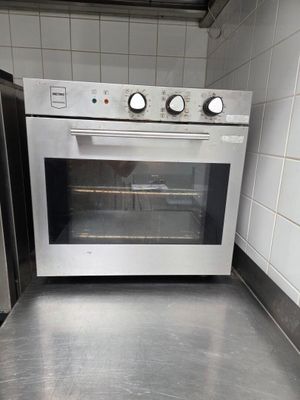 stainless steel counter top in a kitchen with a stove and refrigerator