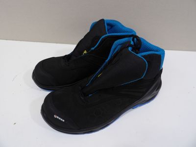 pair of black and blue hiking boots on a white surface