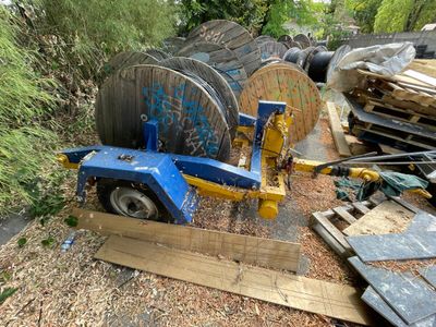 a picture of a blue tow truck parked next to a pile of wood