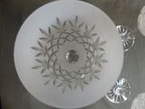 a glass bowl on a glass table with a candle on it