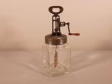 a glass jar with a corkscrew on top of it