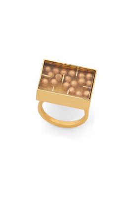 a close up of a gold plated ring with pearls in it