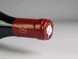 a bottle of wine that has a clock on it