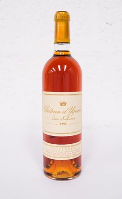 a bottle of wine sitting on top of a white table