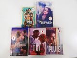 four books on the table that are on top of each other