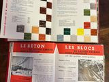 two books on the table are open to show pictures of different buildings
