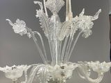a glass chandelier that is hanging from the ceiling