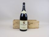une bouteille de vin rouge dans une caisse en bois sur fond blanc