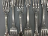 a lot of forks and spoons that are on the table