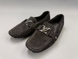 a pair of shoes with a metal buckle on them