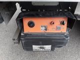 the back end of a truck with an orange and black box on it