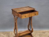a small wooden table with a drawer on top of it