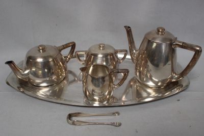 a silver plate with a silver tea set on it