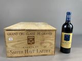 a wooden box with a bottle of wine next to it