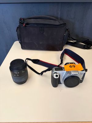 a camera and a lens on a table next to a camera bag