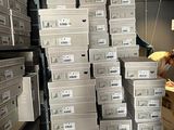many boxes stacked on top of each other in a warehouse