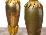 two gold vases sitting next to each other on a table