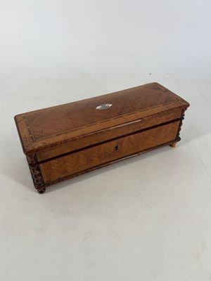 an old wooden box sitting on top of a white surface