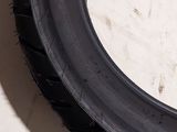 a close up of a motorcycle tire on a tile floor