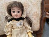 a doll that is sitting on a chair in a room
