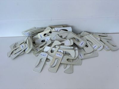a pile of clamps on the floor next to a wall