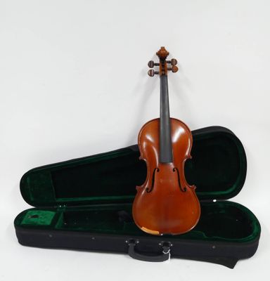 un violon posé dans son étui sur une surface blanche
