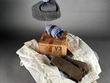 a pile of towels and a hat on top of a box