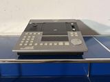 a small electronic device sitting on top of a blue table