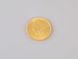 an image of a gold coin on a white surface