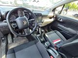 the interior of a small car with black seats and a steering wheel