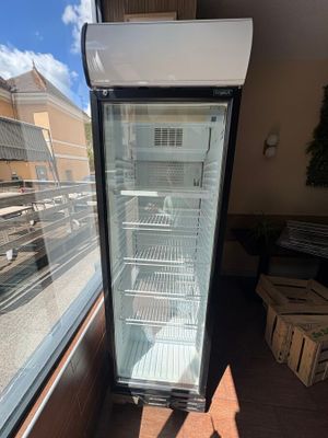 a refrigerator that is sitting in the corner of a building