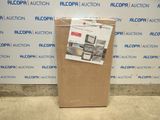 a cardboard box sitting on the floor in front of a wall